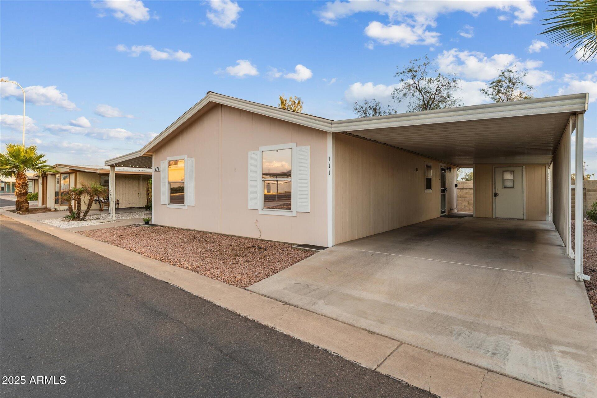 3330 East Main Street, Unit 111 Mesa, AZ 85213 - Photo 20 of 24 a view of a house with a outdoor space and garage