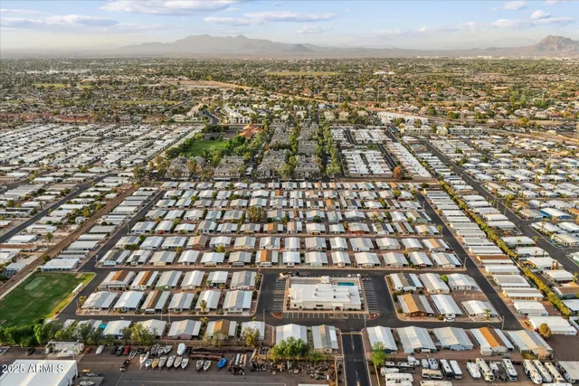 an aerial view of residential building with outdoor space and trees