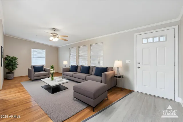 a living room with furniture and a wooden floor