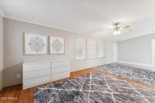 a bedroom with a bed and a painting on the wall