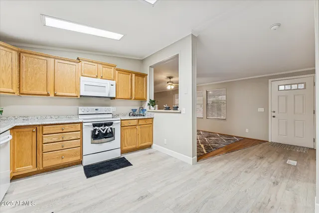 a kitchen with granite countertop a stove a sink and a microwave