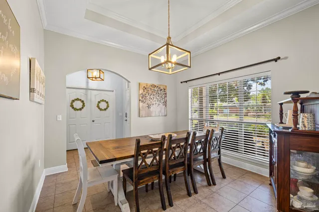 a view of a dining room with furniture and chandelier