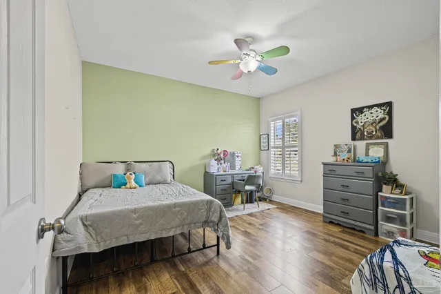 a view of a backyard with swimming pool table and chairs