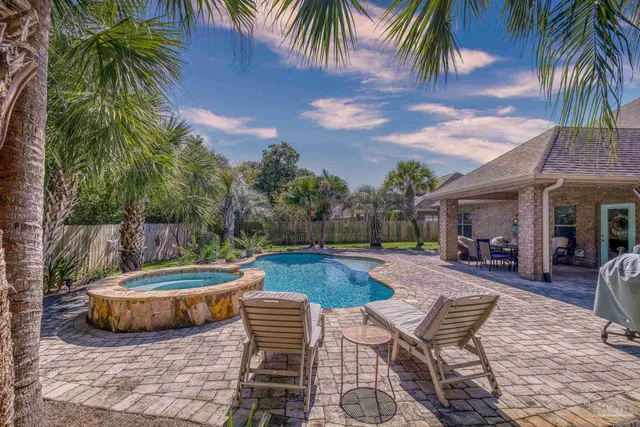 an aerial view of a house with a swimming pool