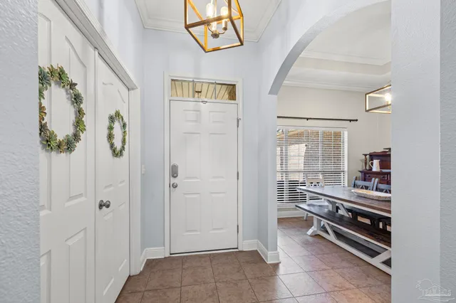 a view of a hallway to a livingroom with furniture and toys