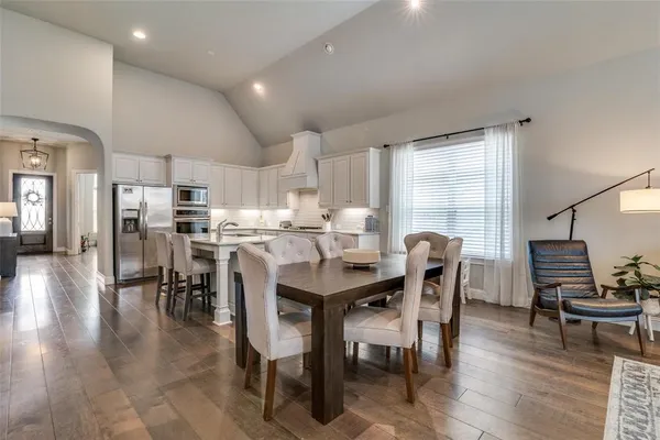 a dining room with furniture and wooden floor
