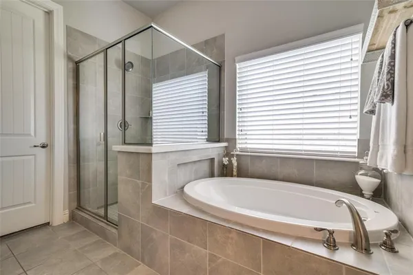 a bathroom with a granite countertop bathtub and shower