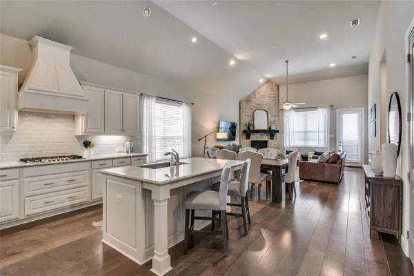 a kitchen with sink stove and cabinets