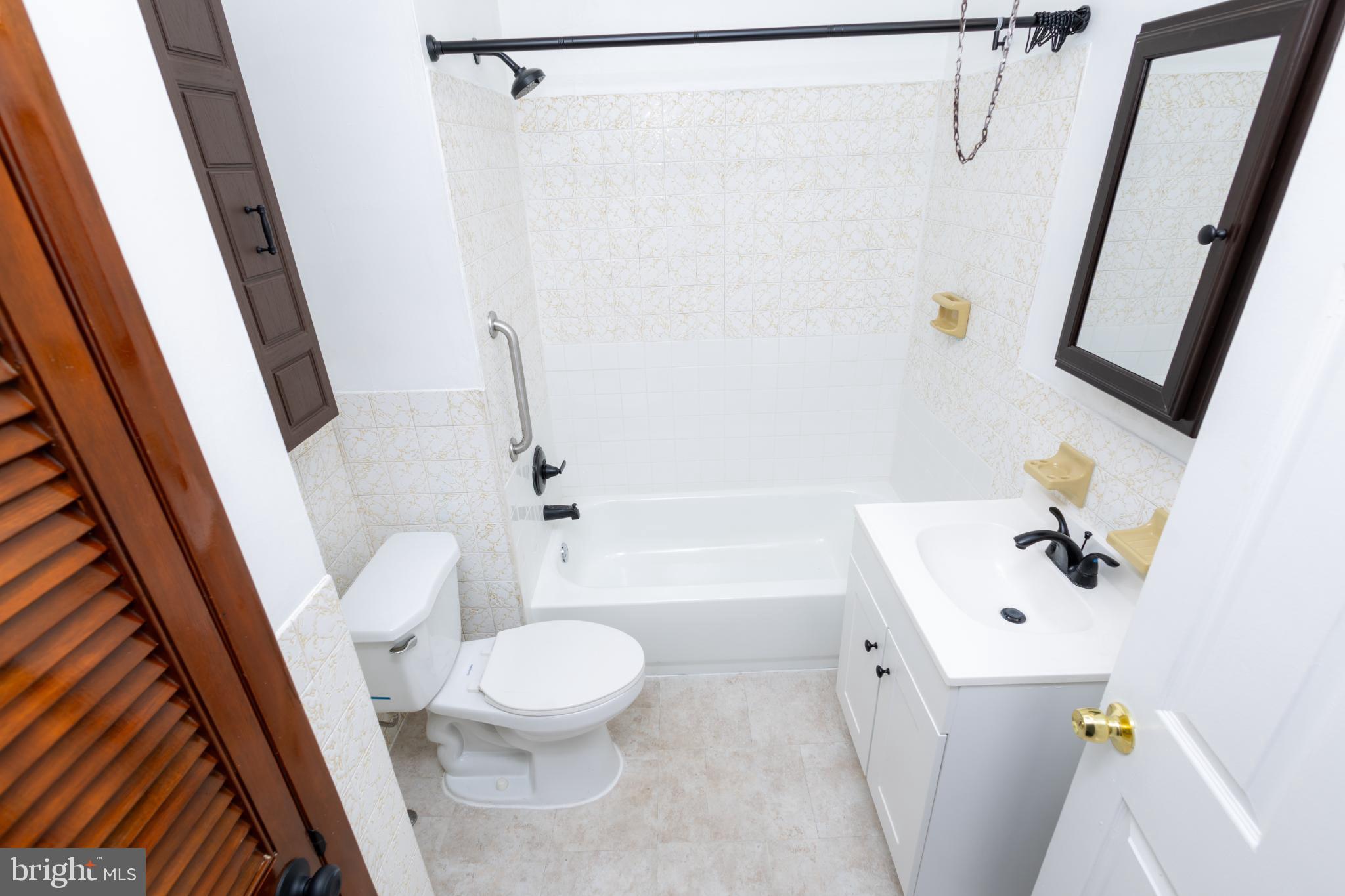 4243 Frost Street Philadelphia, PA 19136 - Photo 17 of 28 a white toilet sitting next to a white sink and tub