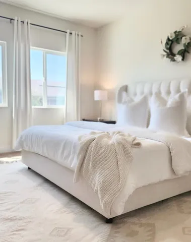 a bedroom with a bed and a window