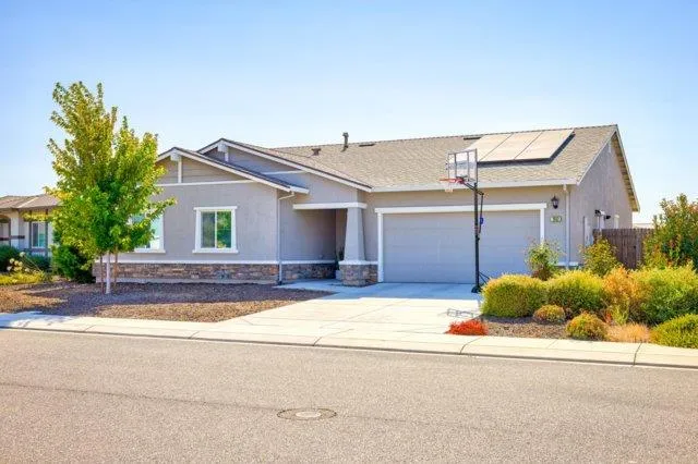 a view of a house with a small yard and plants