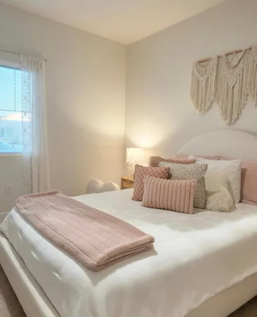 a bedroom with a large bed and a window