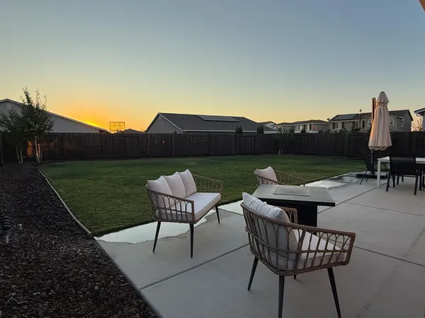 a view of a chairs and table in patio