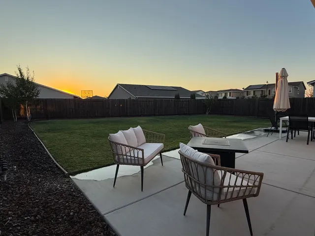 a view of a chairs and table in patio