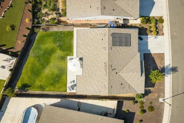 an aerial view of a residential houses with outdoor space