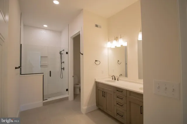 a bathroom with a double vanity sink mirror and double