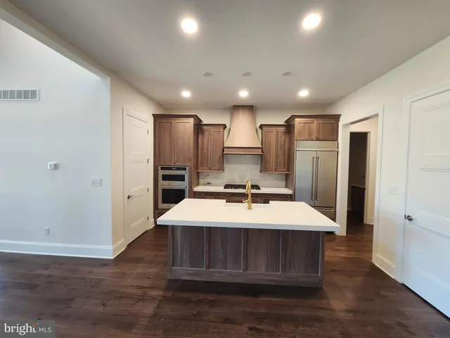 a large kitchen with a table and chairs