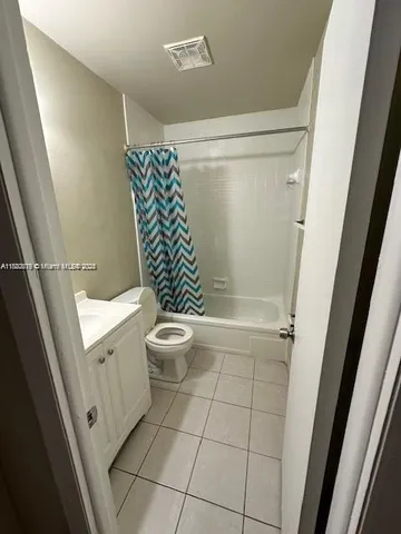 a bathroom with a toilet a sink and shower