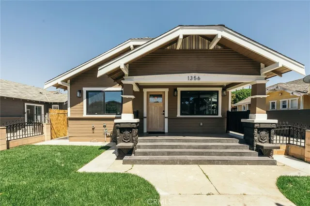 a front view of a house with a yard table and chairs
