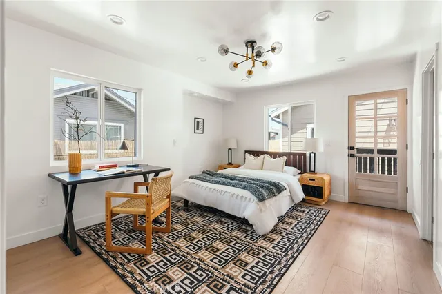 a bathroom with a sink a mirror and a potted plant