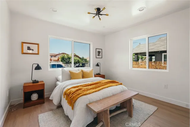 a bedroom with a bed and a large window