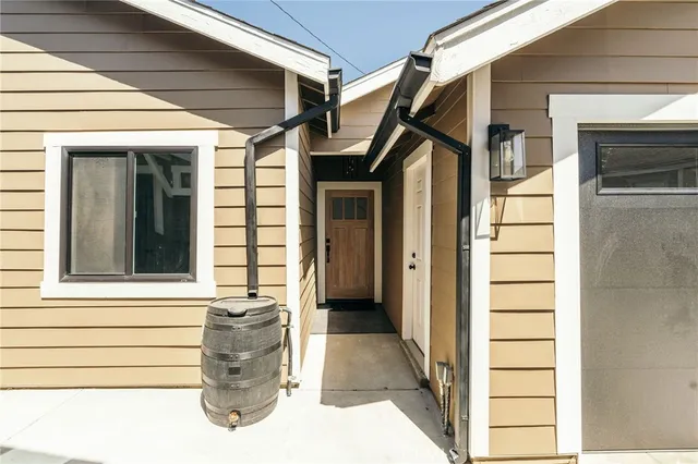 a living room with lots of furniture and kitchen view