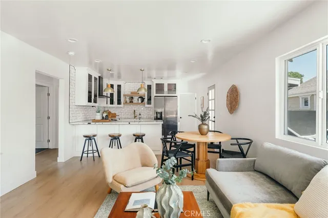 a living room with furniture a dining table and chairs