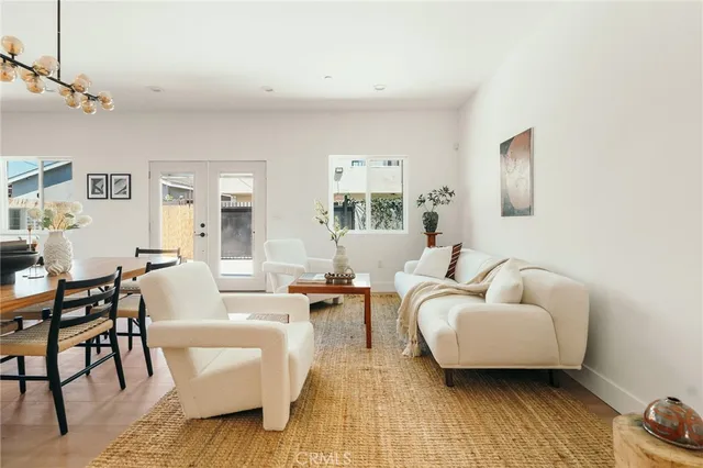 a kitchen with stainless steel appliances a stove a sink dishwasher and white cabinets with wooden floor