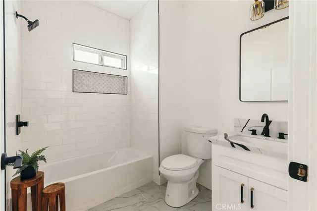 a bedroom with two beds and a couch