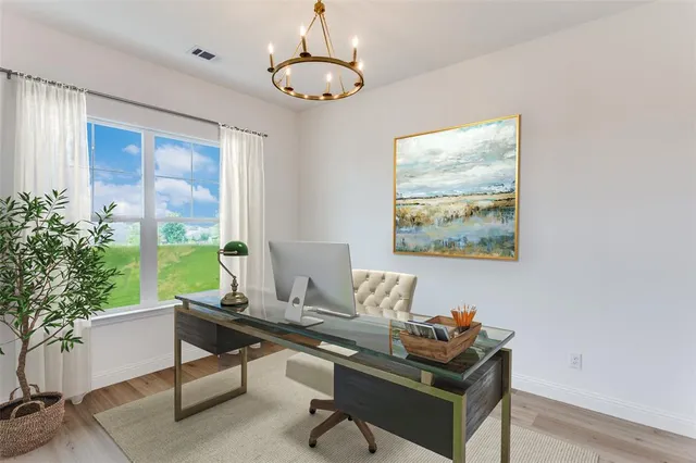a work room with furniture and a potted plant