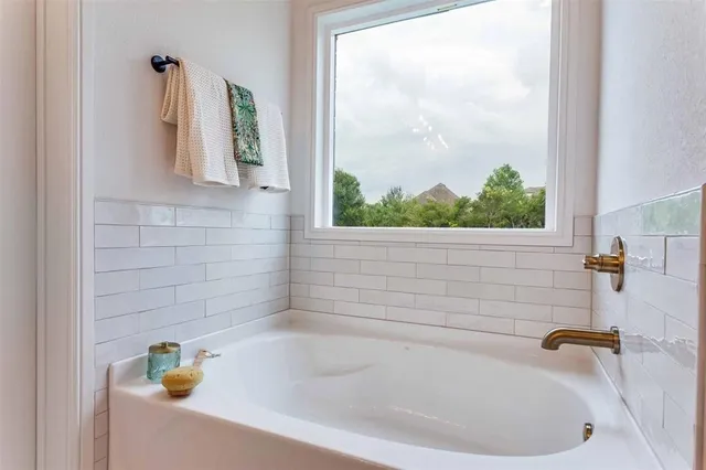 a white bath tub sitting next to a window