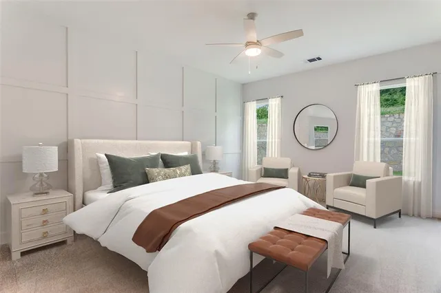 a bedroom with bed and a large window