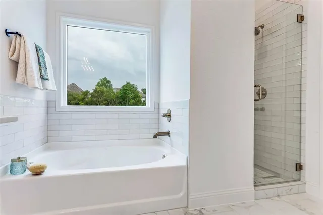 a bathroom with a bathtub and shower