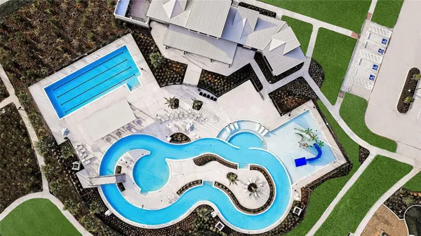 a view of a swimming pool with lounge chairs on th patio