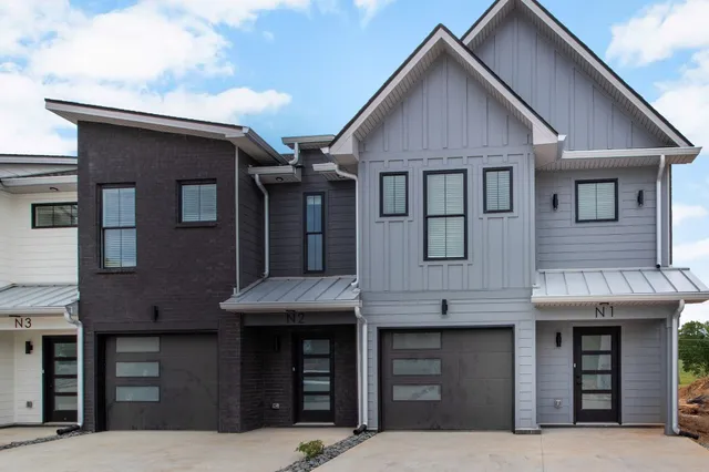 a front view of a house with large windows