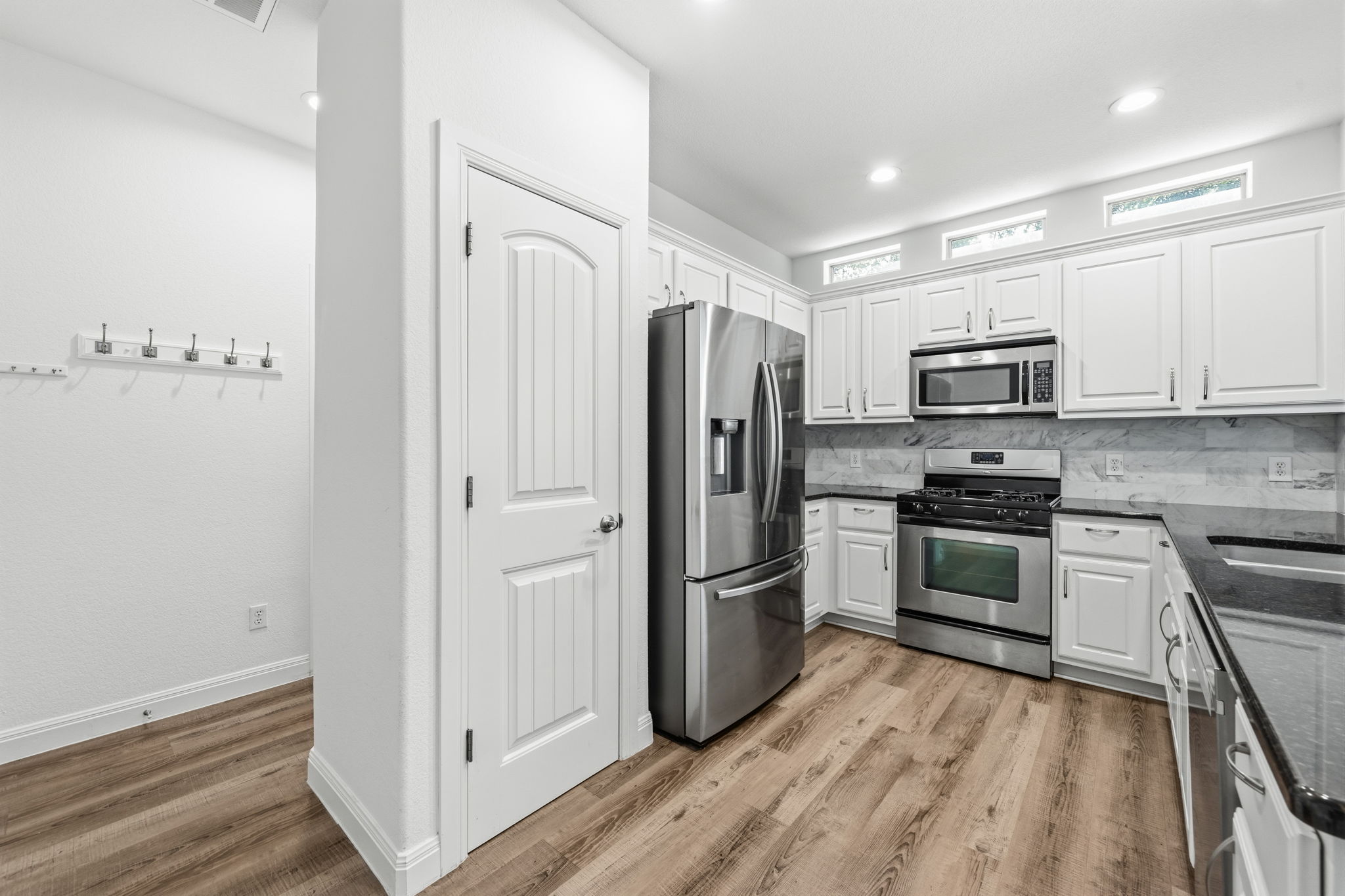 6708 Manchaca Road, Unit 4 Austin, TX 78745 - Photo 9 of 25 Gleaming stainless steel appliances complement the rich granite countertops and warm wood floors in this kitchen.