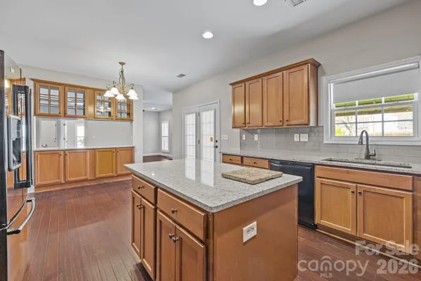 a kitchen that has a sink cabinets counter space and appliances