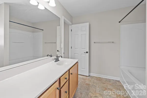 a bathroom with a sink a mirror and a shower