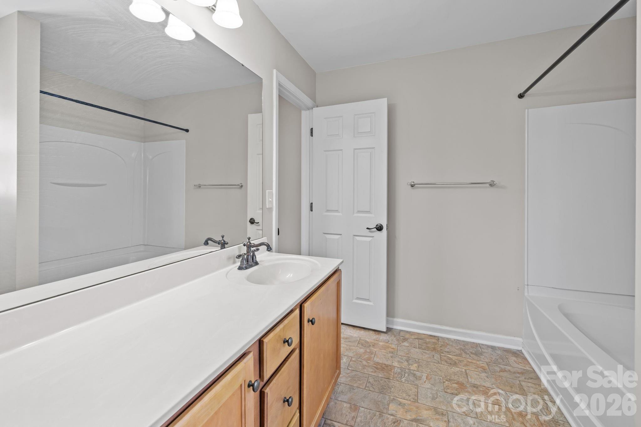 6226 Hermsley Road Charlotte, NC 28278 - Photo 24 of 47 a bathroom with a sink a mirror and a shower