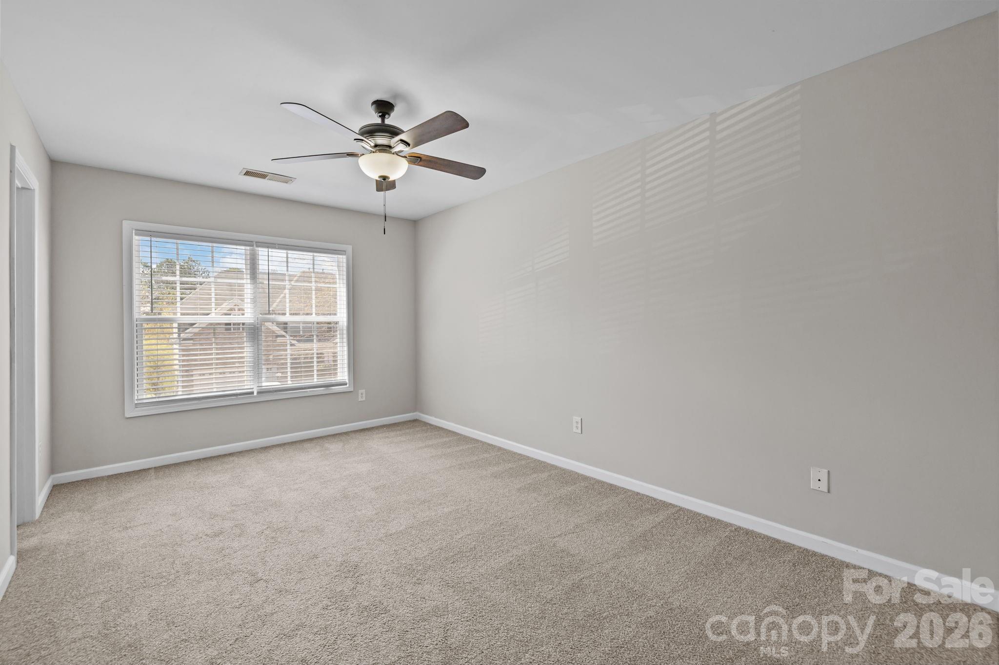6226 Hermsley Road Charlotte, NC 28278 - Photo 26 of 47 an empty room with windows and fan