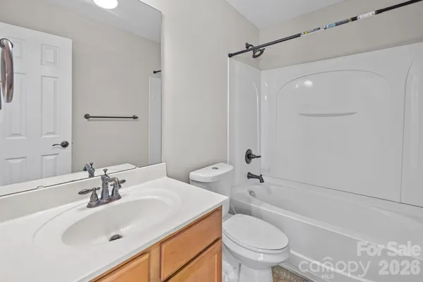 a bathroom with a sink toilet vanity and shower