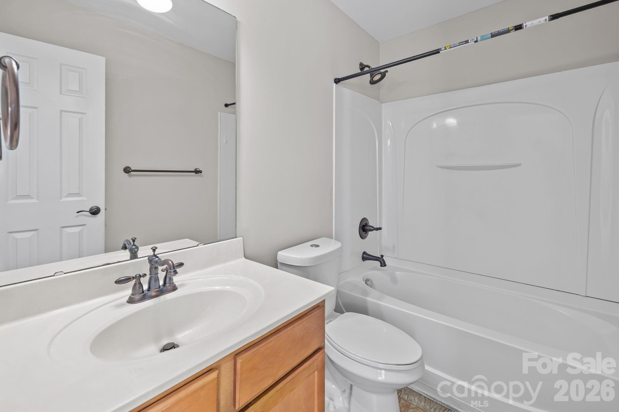 6226 Hermsley Road Charlotte, NC 28278 - Photo 28 of 47 a bathroom with a sink toilet vanity and shower
