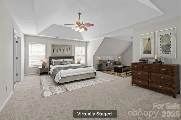 a bedroom with a bed and ceiling fan