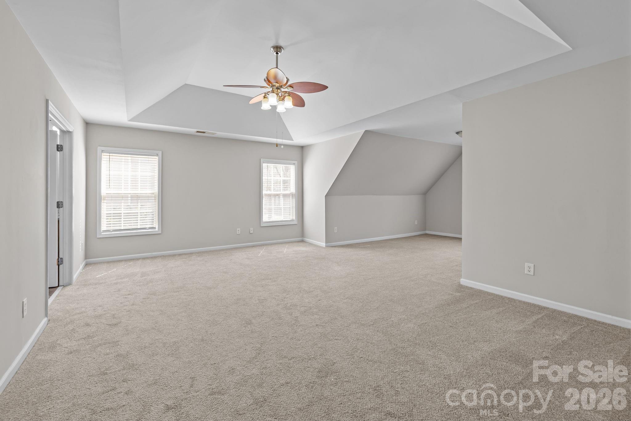 6226 Hermsley Road Charlotte, NC 28278 - Photo 30 of 47 an empty room with windows and chandelier fan