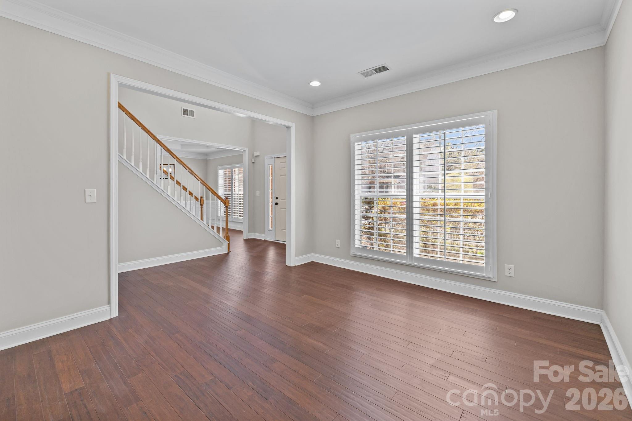 6226 Hermsley Road Charlotte, NC 28278 - Photo 3 of 47 a view of an empty room with wooden floor and a window