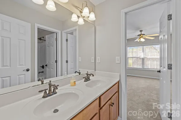 a bathroom with a sink a vanity and a mirror