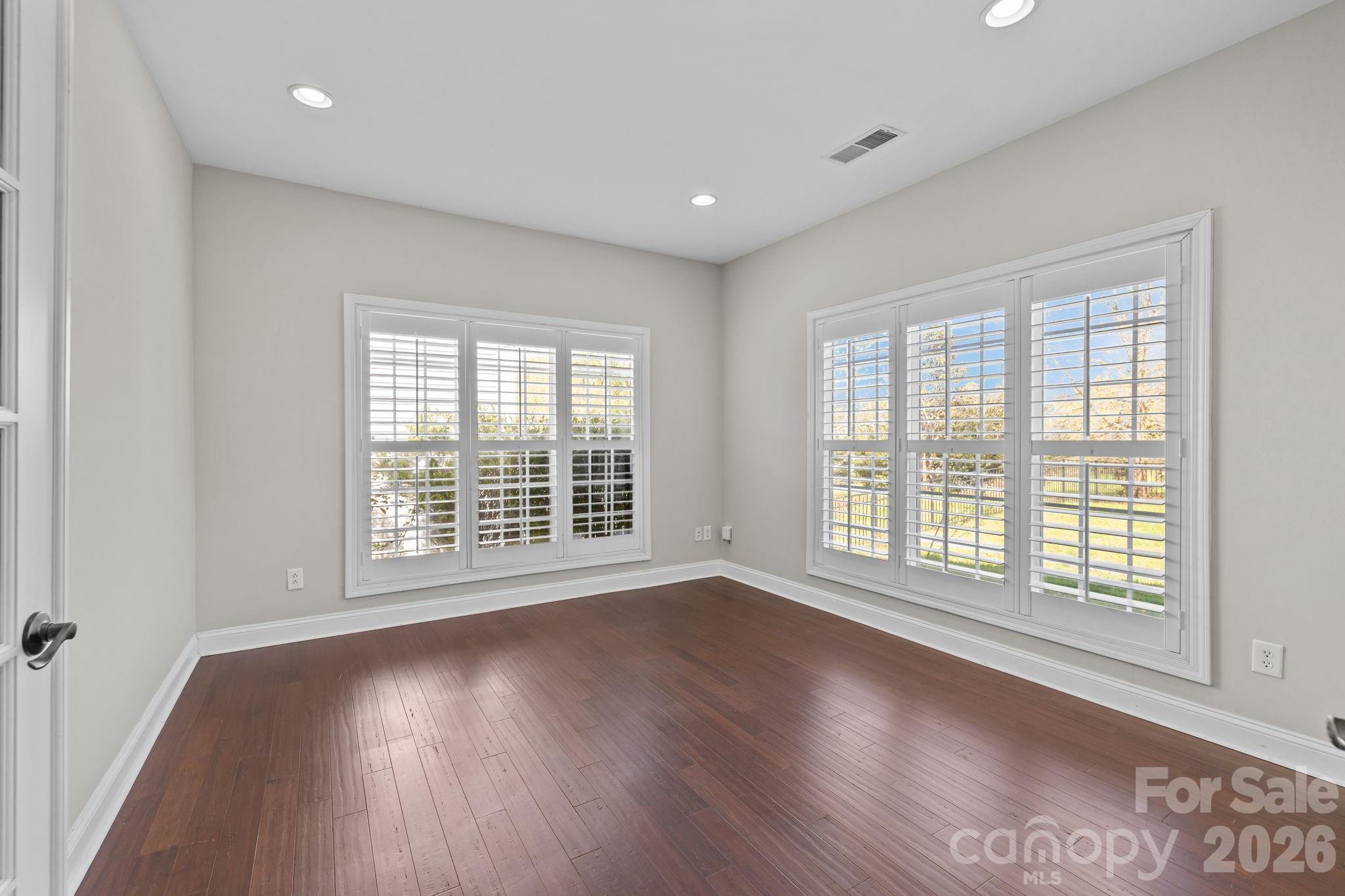 6226 Hermsley Road Charlotte, NC 28278 - Photo 6 of 47 a view of an empty room with wooden floor and a window