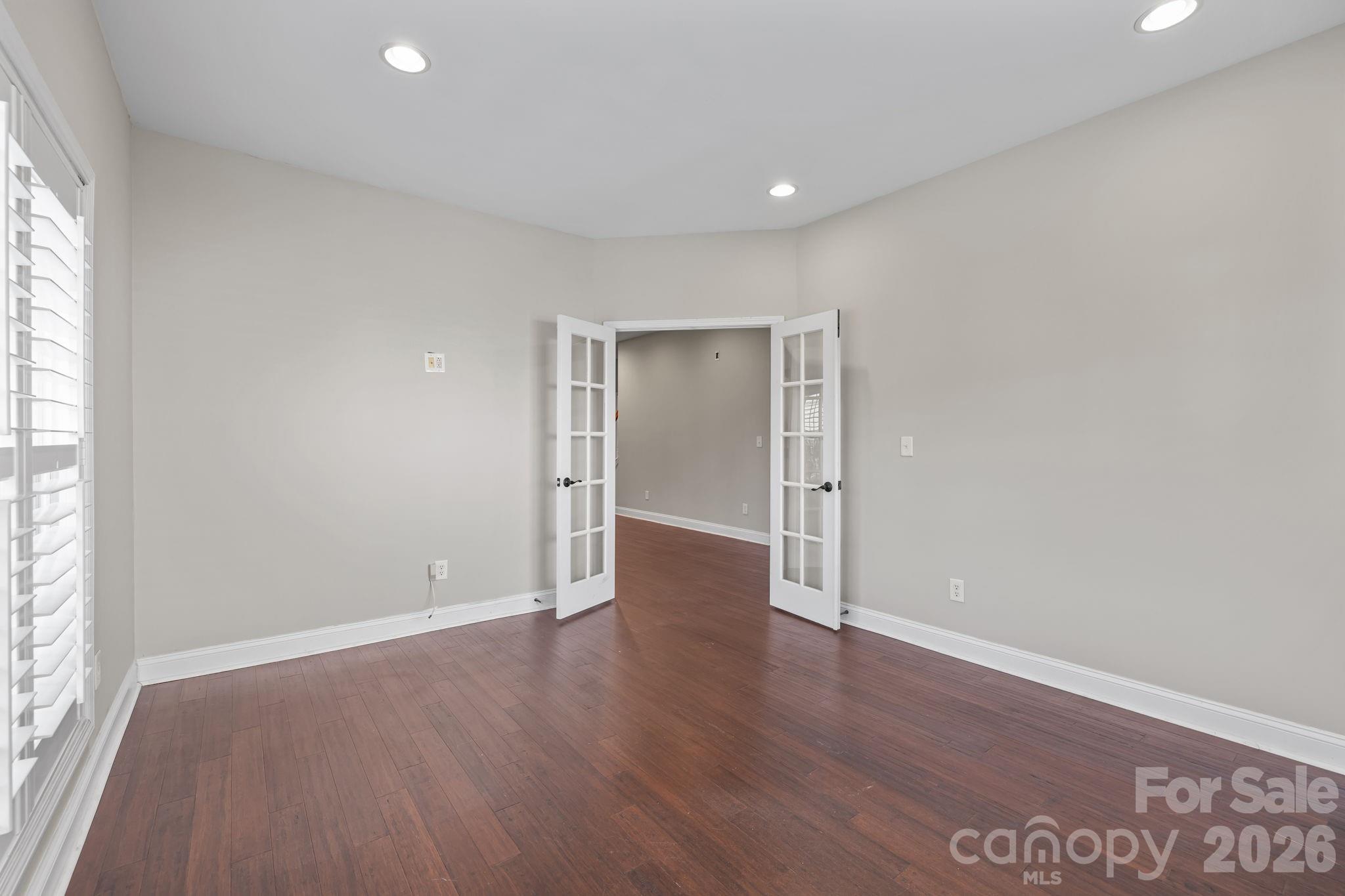 6226 Hermsley Road Charlotte, NC 28278 - Photo 7 of 47 an empty room with wooden floor & windows