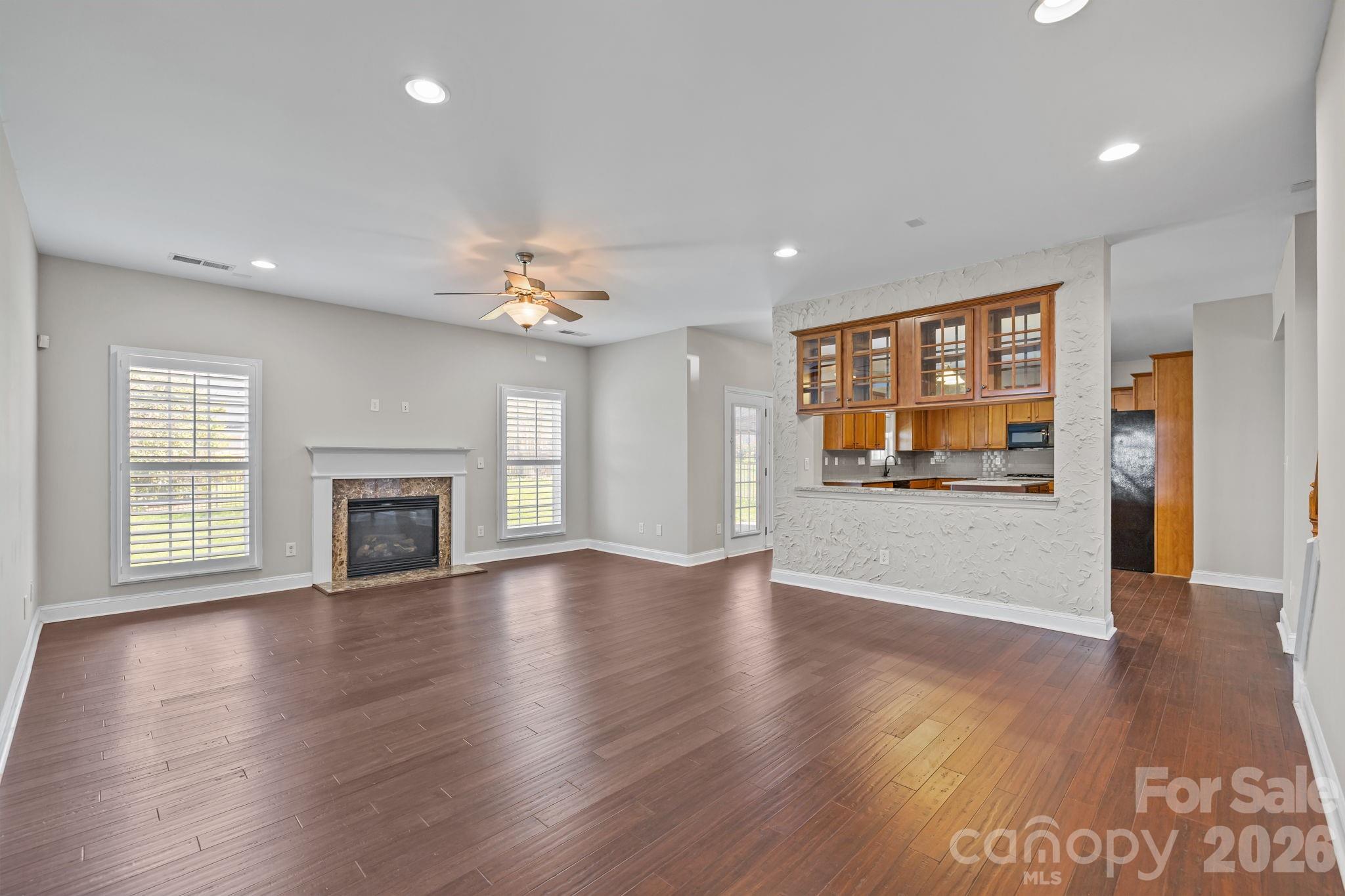 6226 Hermsley Road Charlotte, NC 28278 - Photo 8 of 47 a view of an empty room with window and wooden floor