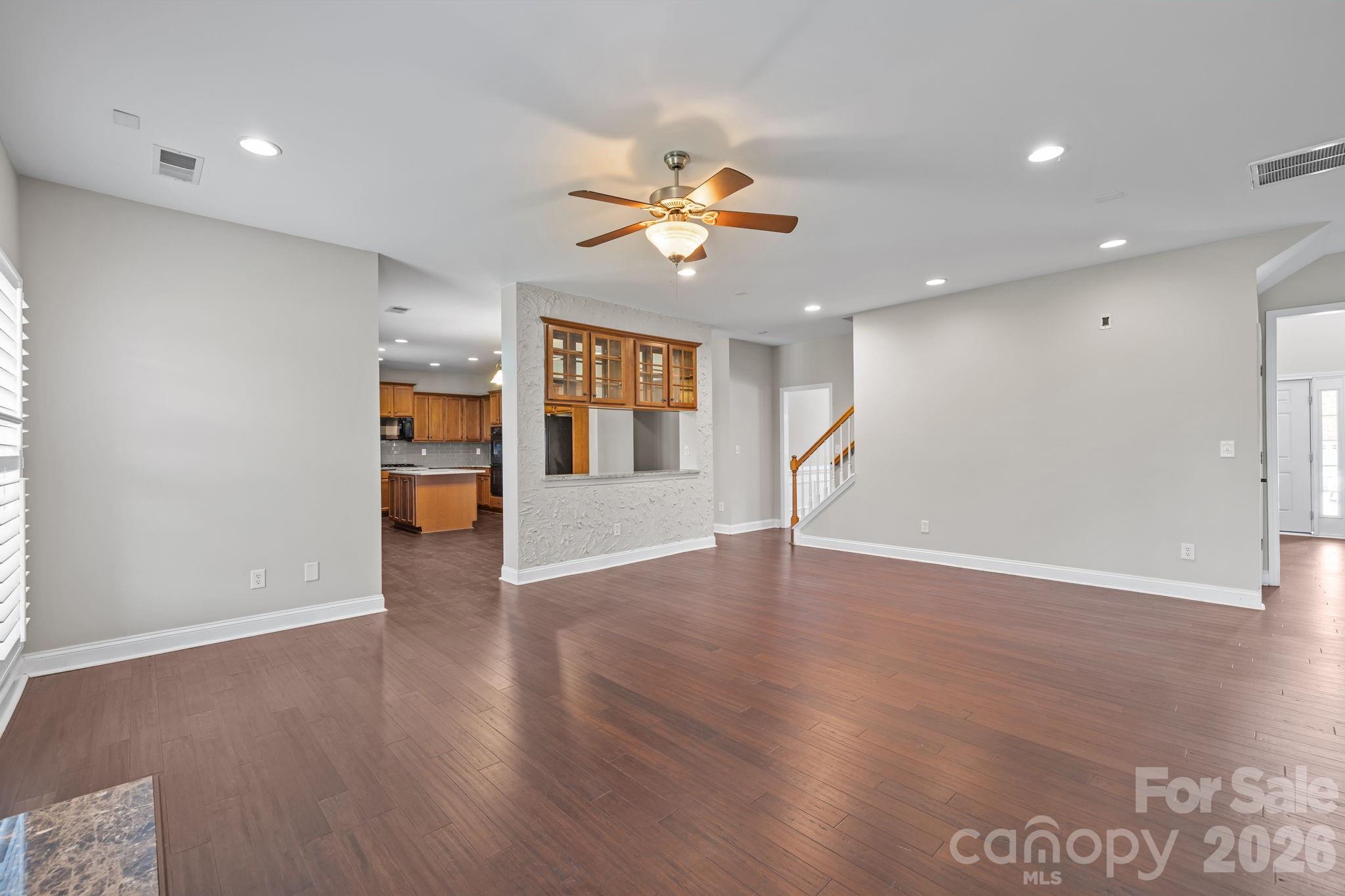 6226 Hermsley Road Charlotte, NC 28278 - Photo 9 of 47 a view of empty room with wooden floor and fan